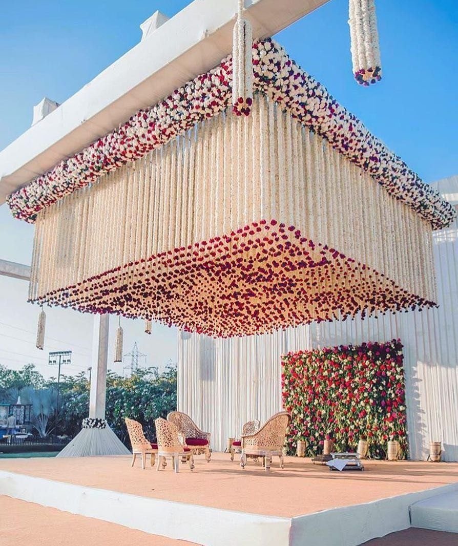 Marigold and rose ceiling canopy installation with seating below