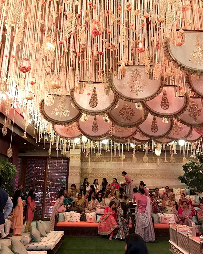 Hanging floral fixtures over lounge seating at indoor celebration