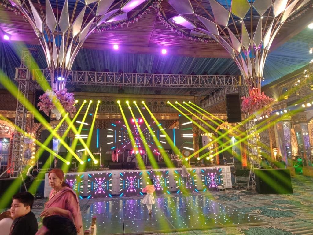 Family on dance floor under green stage lighting