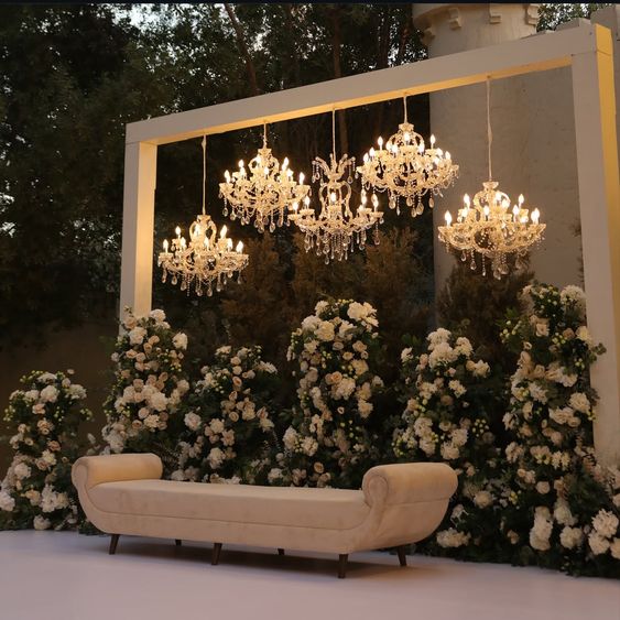 Romantic anniversary decoration in Delhi with candles, fairy lights, and rose petals creating an elegant setup for couples.